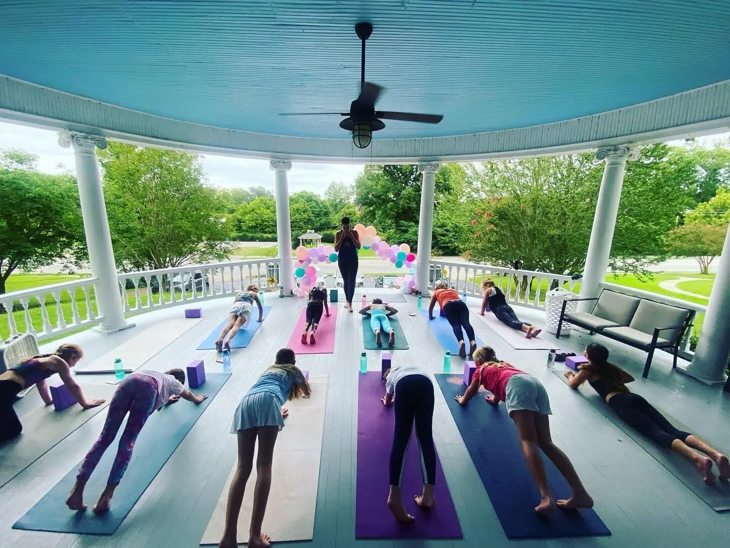 Yoga class on the turquoise wraparound porch of The Edwardian Inn