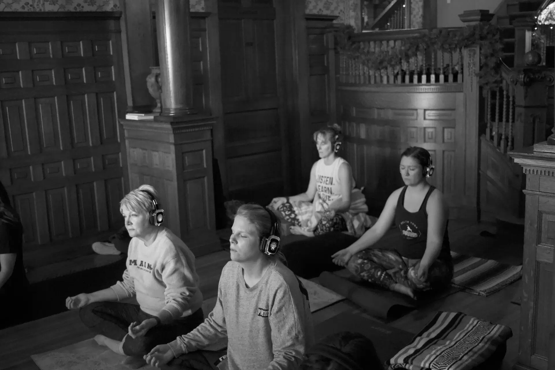 Meditation session with headphones by the historic staircase at The Edwardian Inn