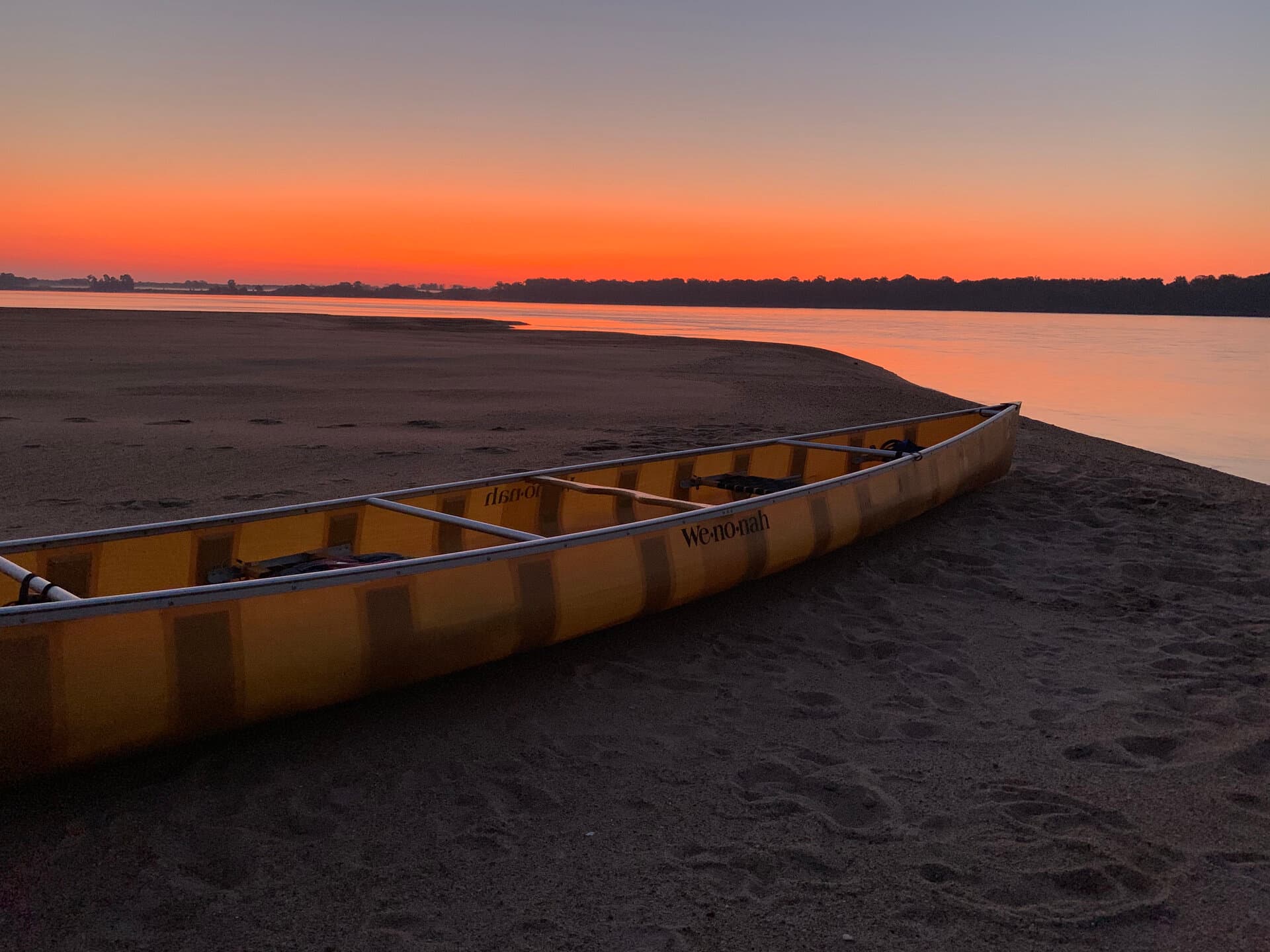 Canoe on Mississippi River sandbar at sunset